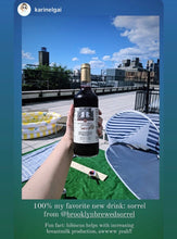 Load image into Gallery viewer, Caribbean Nonalcoholic Sorrel Mocktail and cocktail beverage that tastes better than wine. The hibiscus-spiced brewed and aged bottled sorrel enjoyed solo or as a mixer. The recommended zero-proof Black-owned,booze-free Woman-owned beverage business.