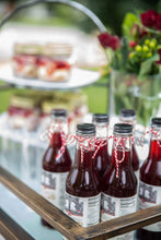 Load image into Gallery viewer, Our bottled non-alcoholic sorrel is a Caribbean drink brought in Brooklyn. It's a healthy Black-owned, Woman-owned, Muslim-owned, Caribbean-owned beverage you can buy for holiday party or for gifting. Serve it for cheese pairings, sober party or corporate events.