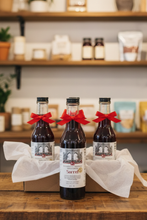 Load image into Gallery viewer, 4 8oz bottles decorated in red thin ribbon displayed in a gifting shop